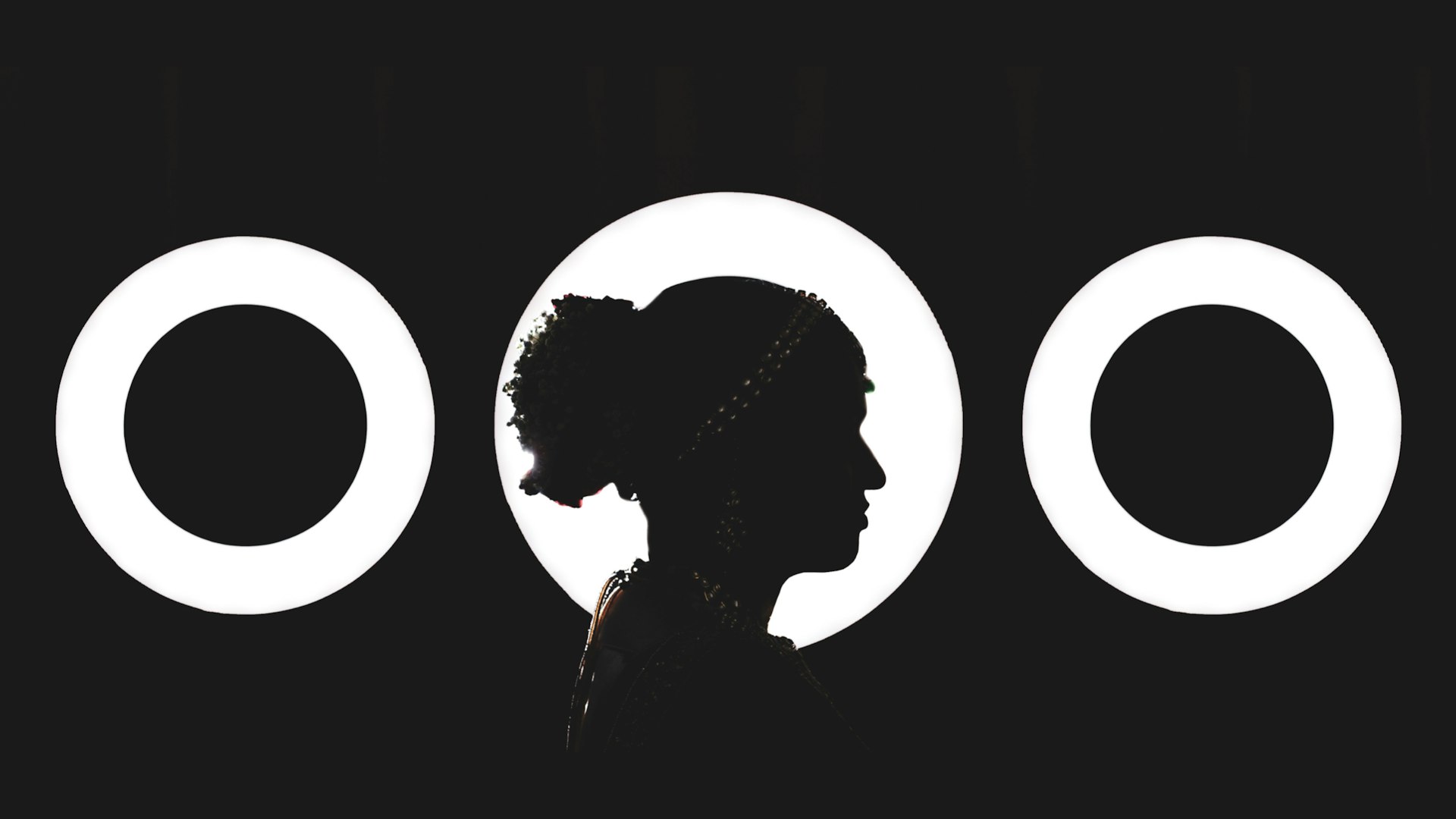a woman standing in front of three circles
